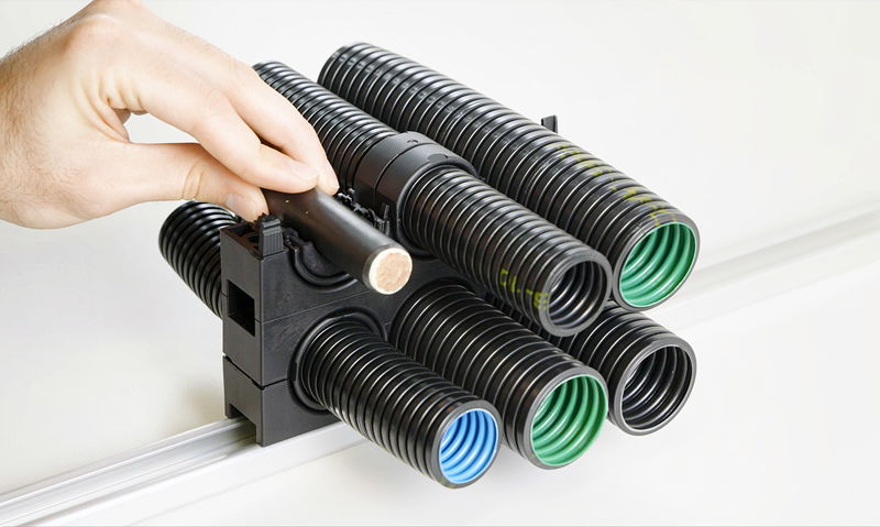 Kompaktes Haltersystem für Wellrohre und Kabel