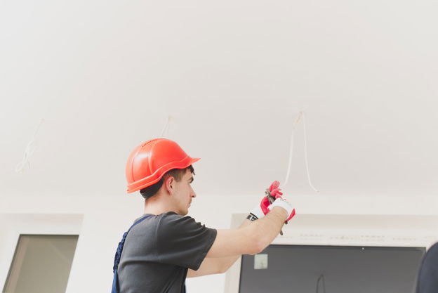 Do I need to adhere to regulation 522.6.204 when installing cable in a ceiling?